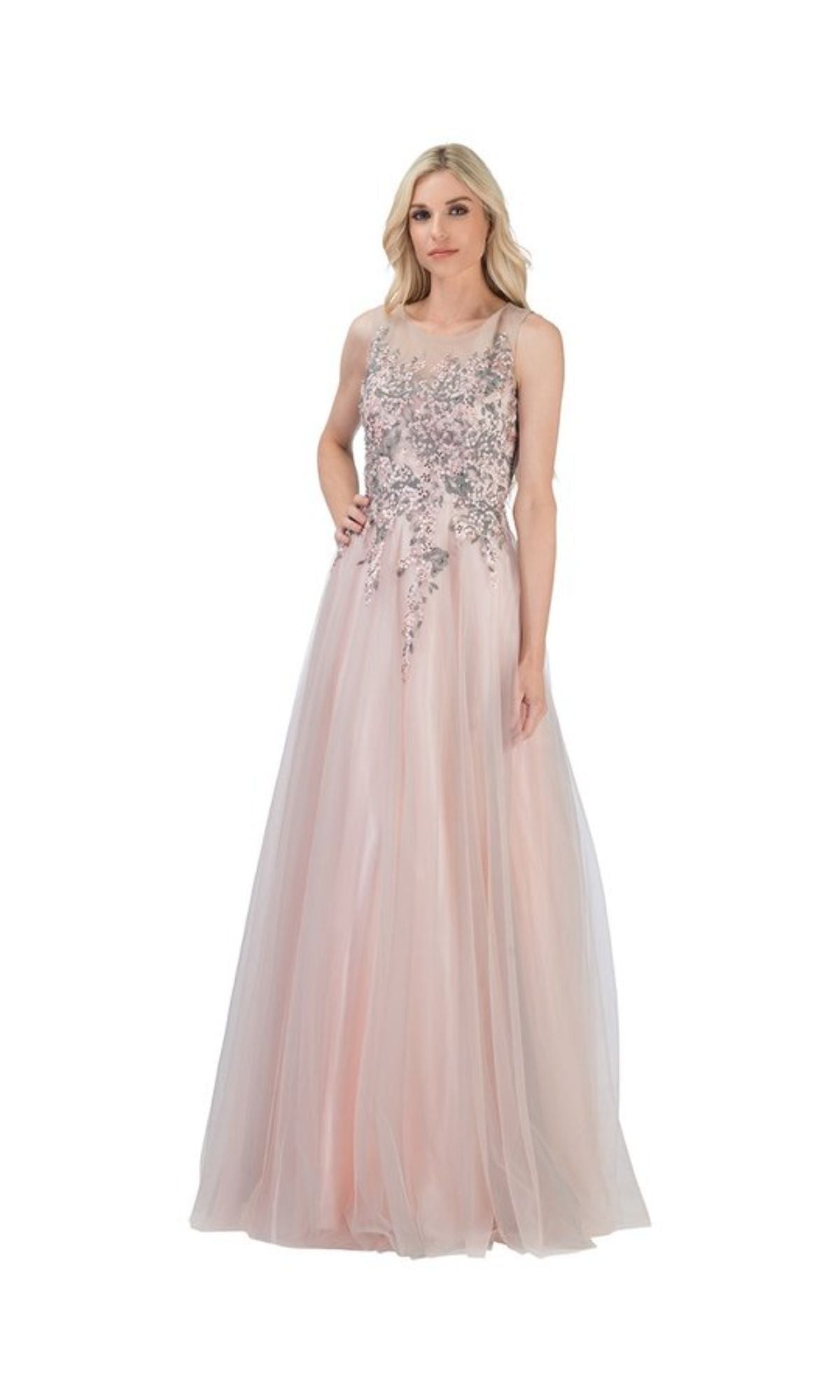 A woman in the Blush Pink Long Prom Ball Gown: Chicas C7545, a sleeveless floor-length a-line dress with floral embellished bodice, stands against a white background.